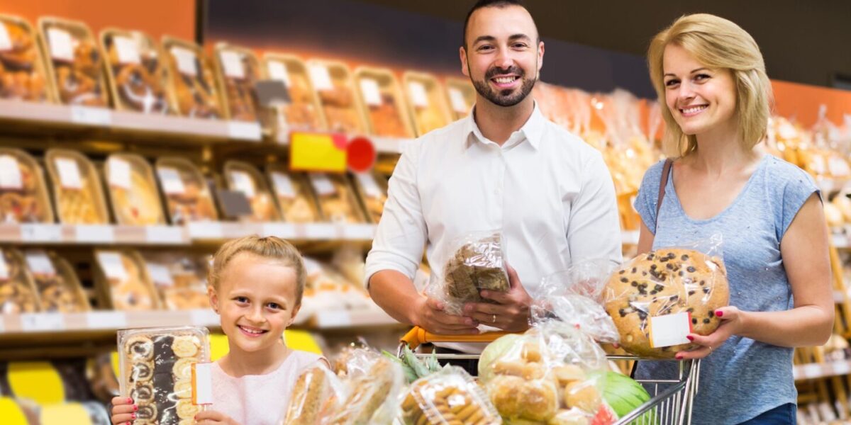 Portrait,Of,Happy,European,Family,Choosing,Bread,And,Sweets,In